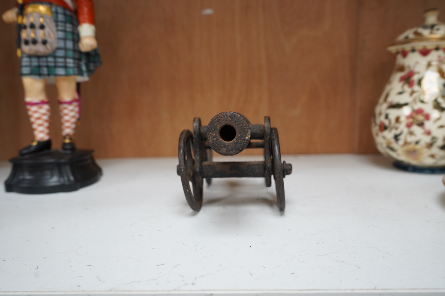 A miniature cast iron table canon, 19cm in length. Condition - fair